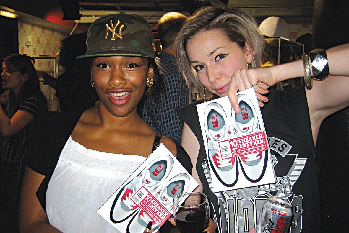Two girls holding up copies of Sneaker Freaker Issue 10 at the launch in London