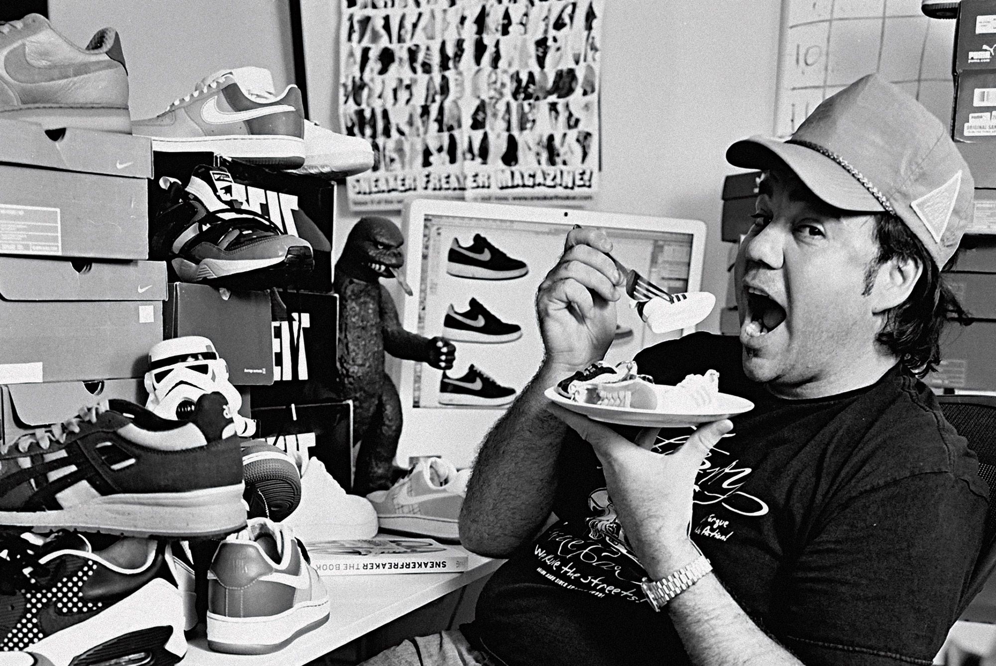 Sneaker Freaker founder, Woody, surrounded by shoes and shoeboxes.